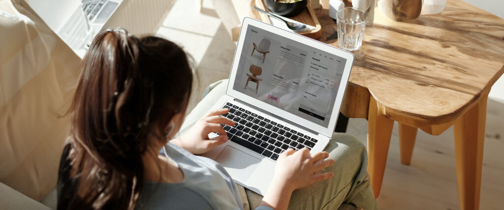 Woman on a laptop looking at a furniture e-commerce website